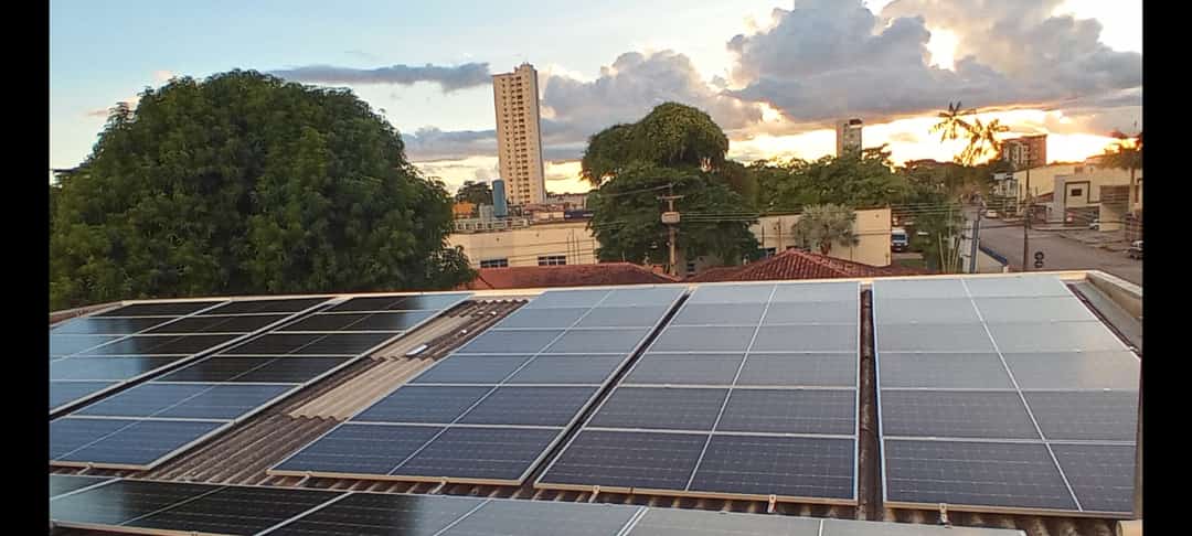 Painéis solares instalados em telhado com vista da cidade de Porto Velho ao fundo